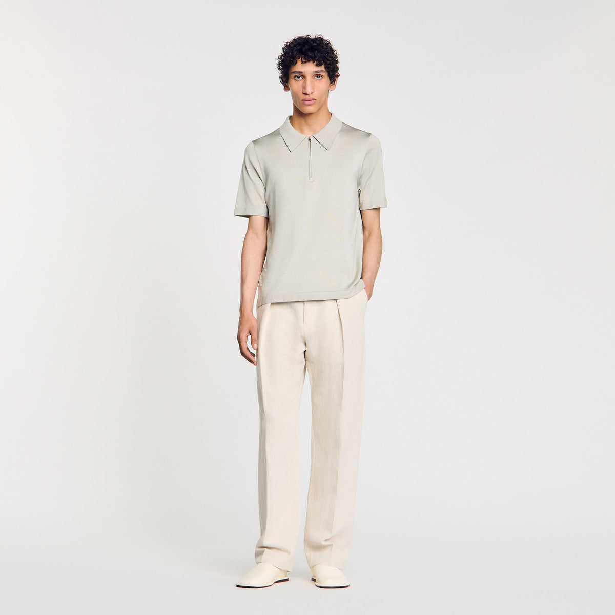 Knitted polo shirt with zip collar | Sandro